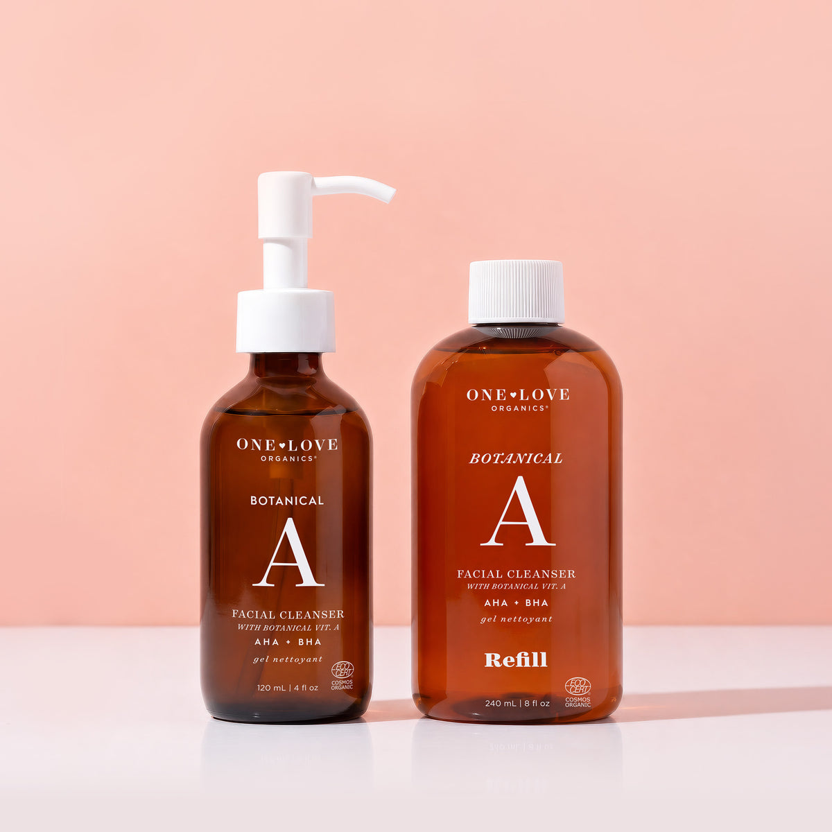 Two bottles of One Love Organics Botanical A Facial Cleaners on a peach background