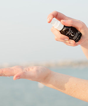 A person holding a bottle of botanical c 