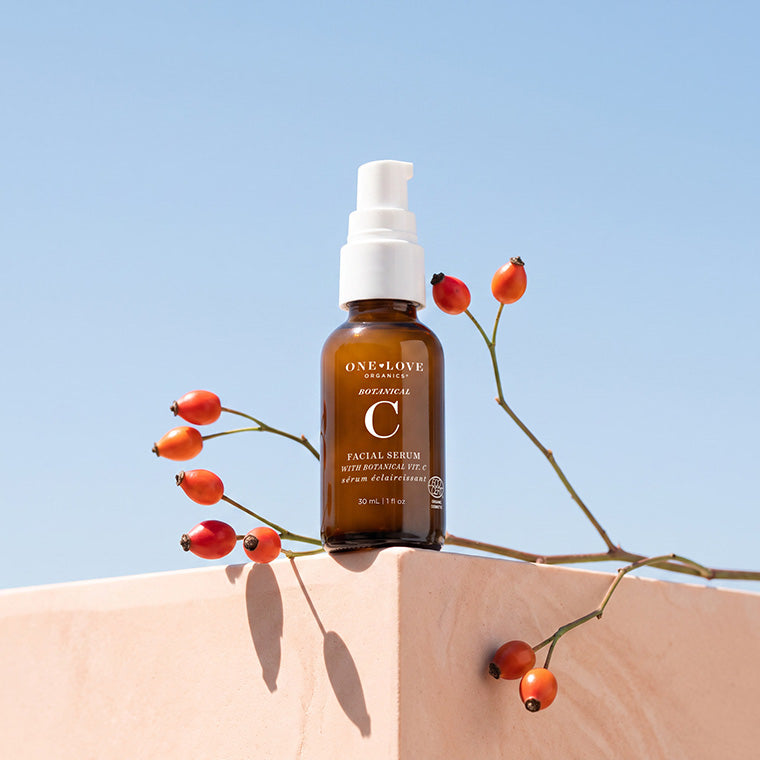 An amber bottle of botanical C facial serum  styled outdoors 
