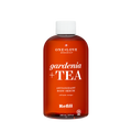 A 240 mL amber-brown bottle of One Love Organics Gardenia + Tea Antioxidant Body 