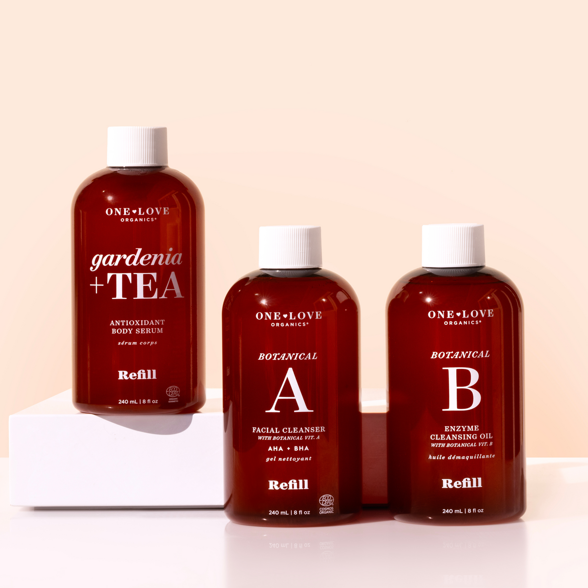three bottles of one love organics products including the gardenia and tea, botanical a and botanical b