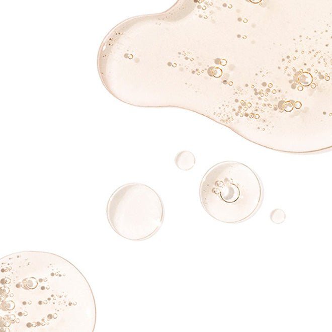 A close-up studio shot of a translucent, pale pink cosmetic gel 