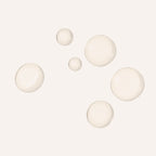 Five translucent, frosted glass-like spheres in varying sizes scattered on a solid off-white background.