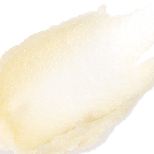 A close-up texture shot of a pale, creamy off-white cosmetic cream or gel on a solid white background.