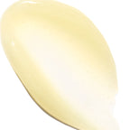 A close-up swatch of a pale creamy yellow cosmetic